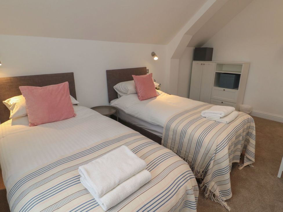 A bedroom with two single beds and a dresser at Harvest Cottage 2 Berwick-upon-Tweed