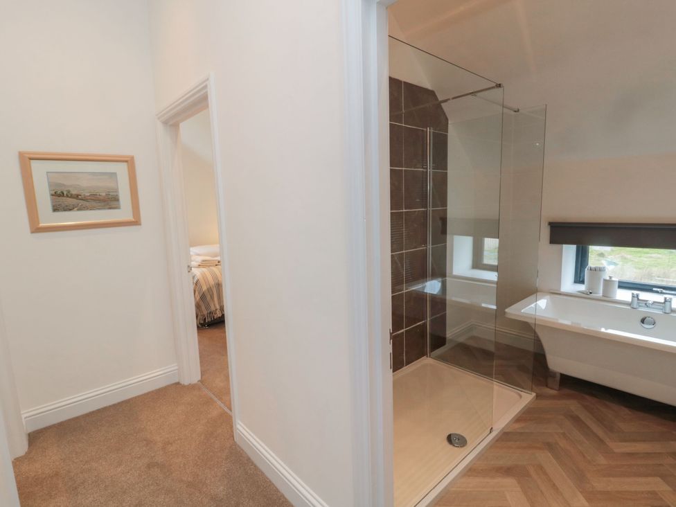 A bathroom with a shower and bathtub at Harvest Cottage 2 in Berwick-upon-Tweed