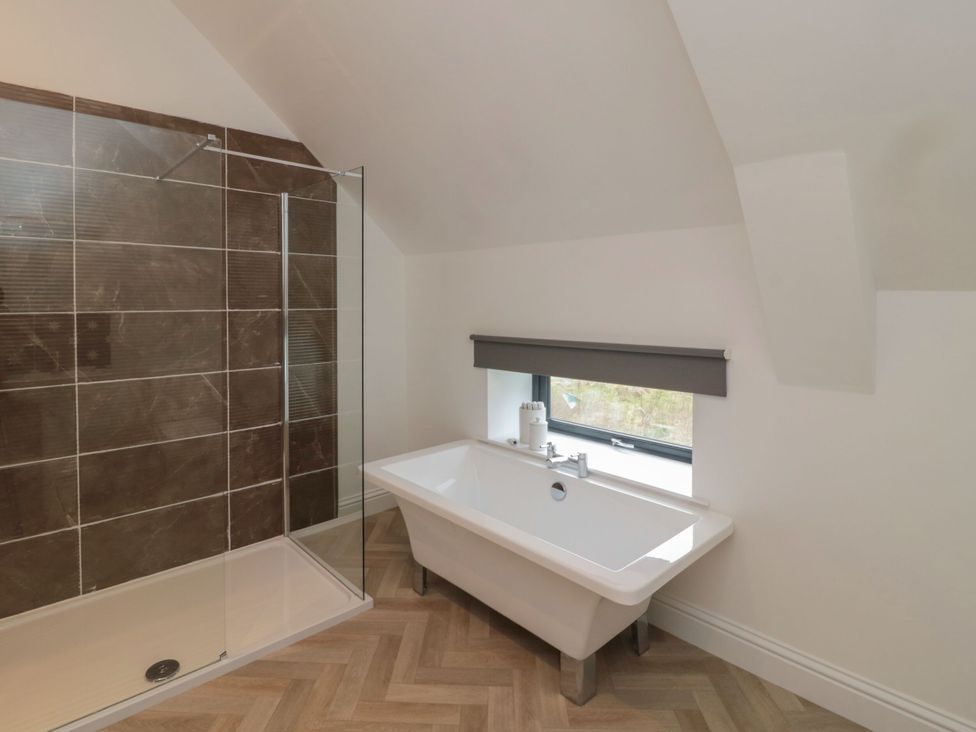 A bathroom with a shower and bathtub at Harvest Cottage 2 Berwick-upon-Tweed
