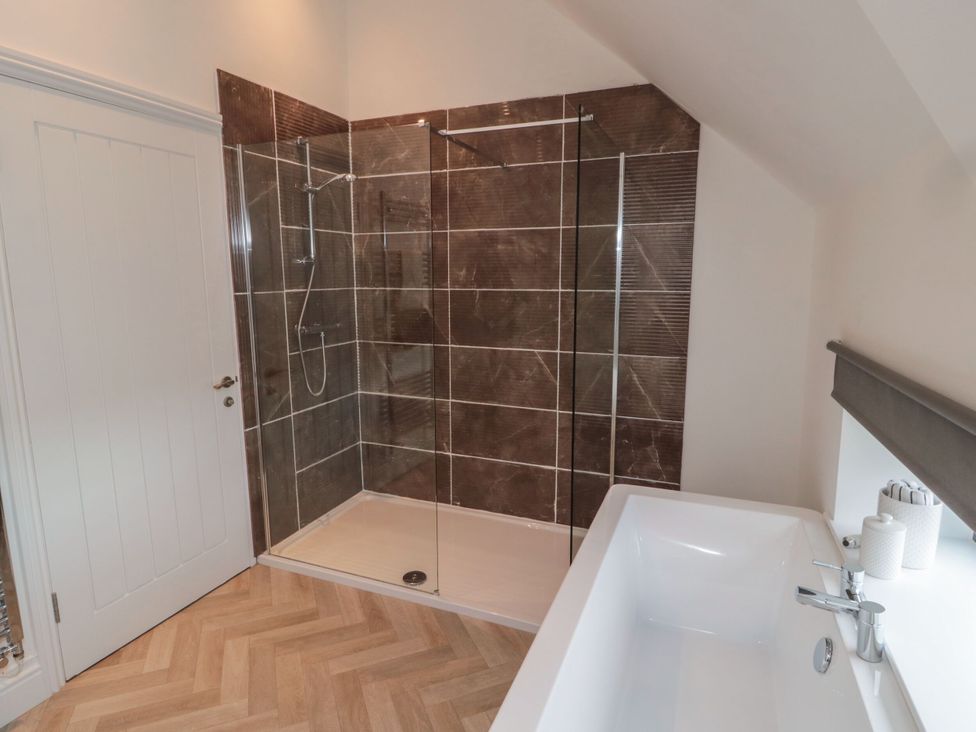 A bathroom featuring a shower and a bathtub at Harvest Cottage 2 Berwick-upon-Tweed