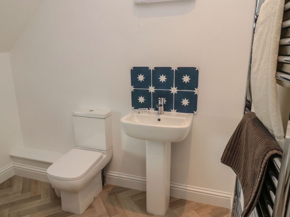 A bathroom with a toilet and sink at Harvest Cottage 2, Berwick-upon-Tweed