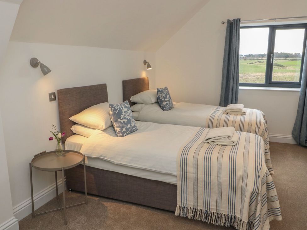A bedroom with two twin beds and a window at Harvest Cottage 2 Berwick-upon-Tweed