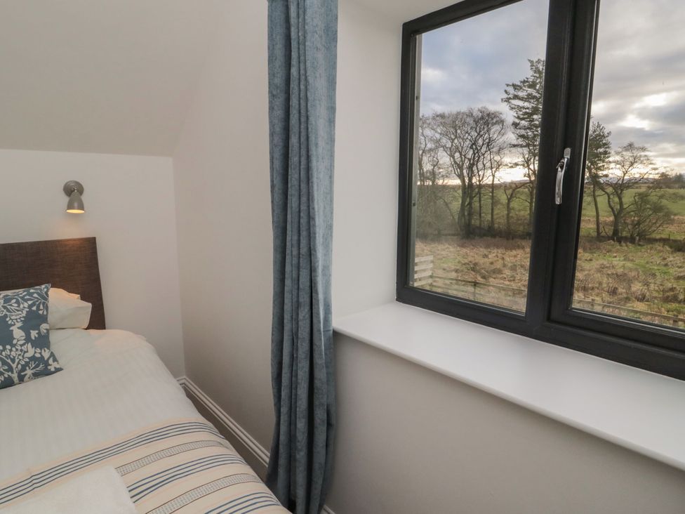 A bedroom with a bed and window at Harvest Cottage 2 Berwick-upon-Tweed