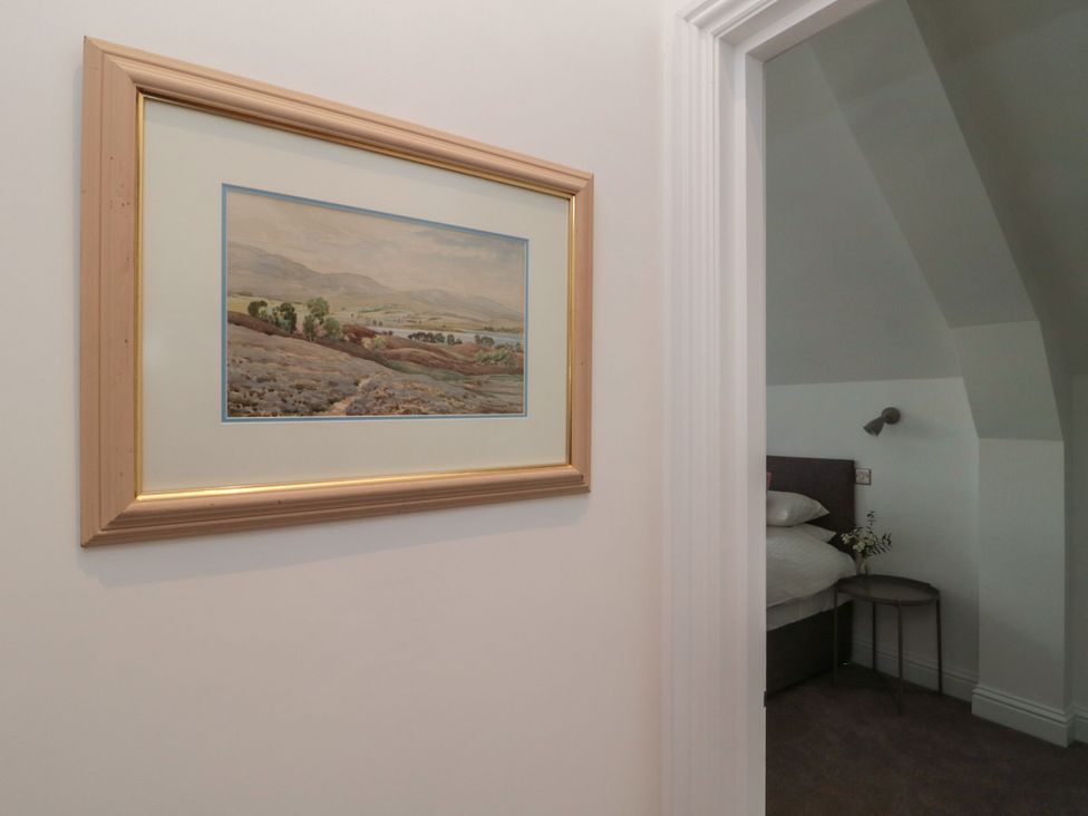 A framed painting in a bedroom with a doorway to another area at Harvest Cottage 2 Berwick-upon-Tweed