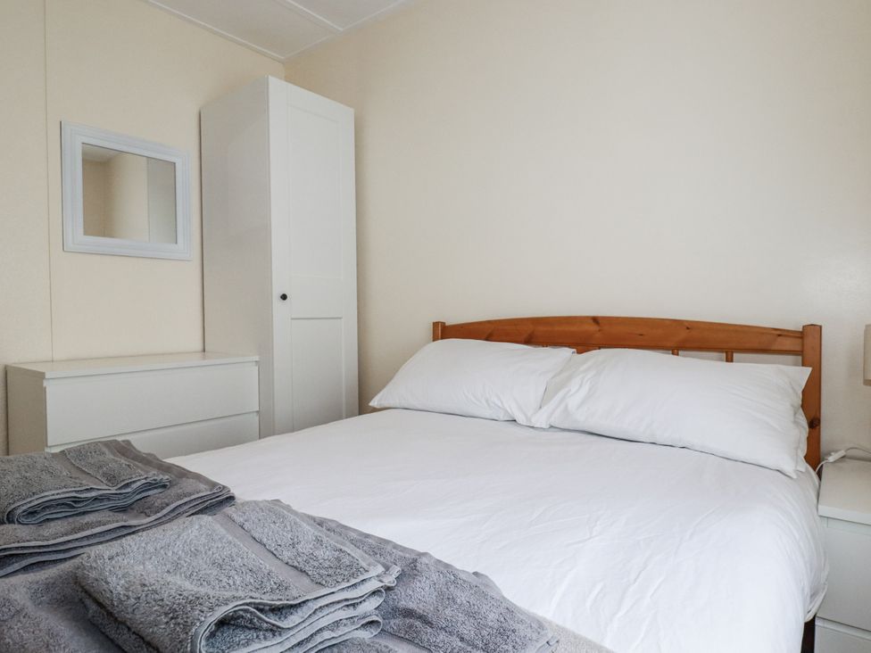 A bedroom with a bed and wardrobe at Sea Ledge in Tintagel