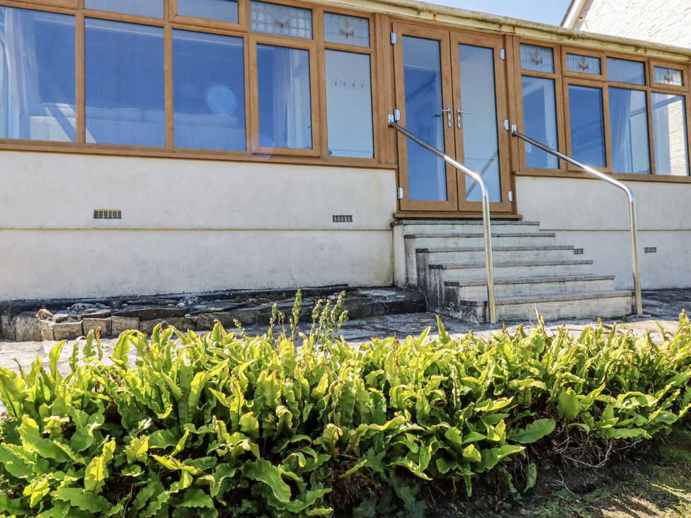 An exterior view of a building with steps and plants at Sea Ledge in Tintagel