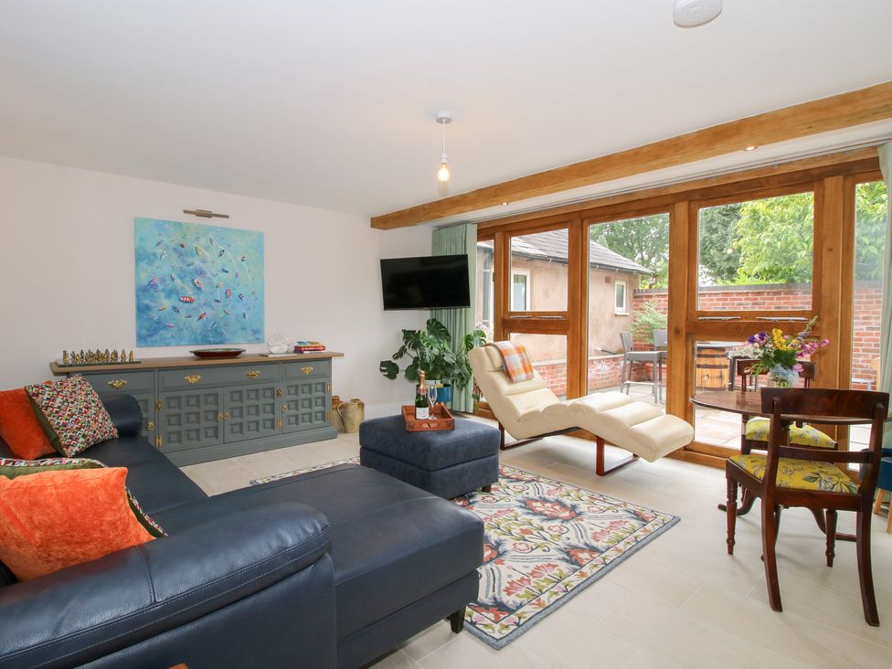 A living room with a sofa and a coffee table at Sylva Cottage Burlton near Cockshutt