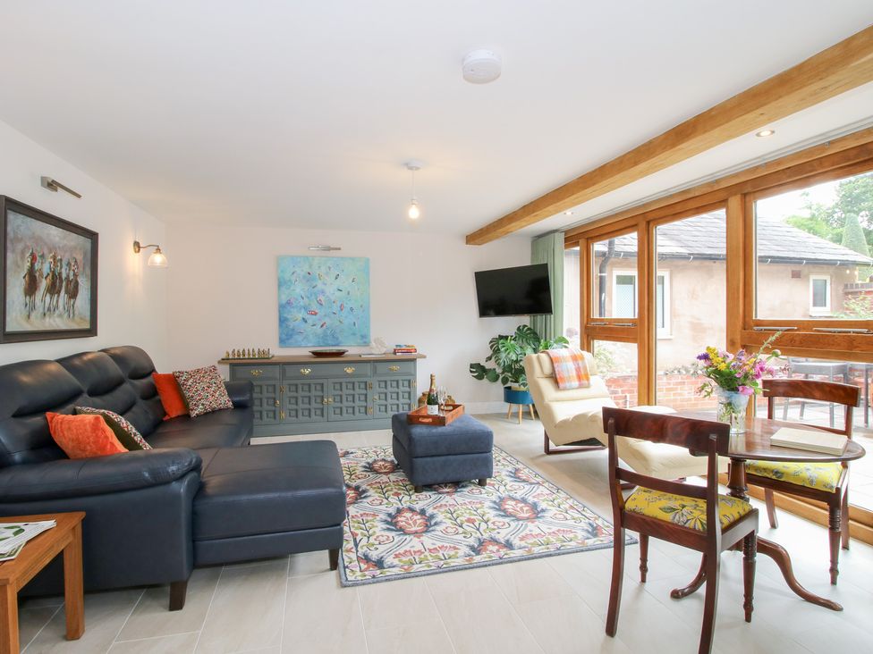 A living room with a sofa and coffee table at Sylva Cottage in Burlton near Cockshutt