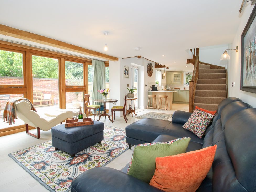 A living room with a sofa and a table in Sylva Cottage Burlton near Cockshutt