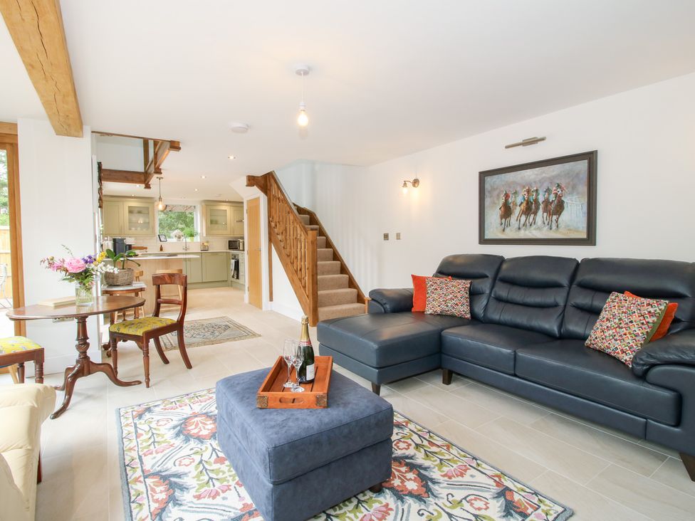 A living room with a sofa and dining table at Sylva Cottage in Burlton near Cockshutt