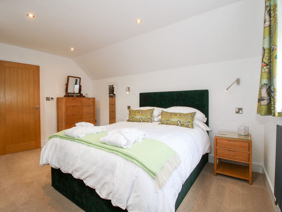 A bedroom with a bed and a dresser at Sylva Cottage Burlton near Cockshutt