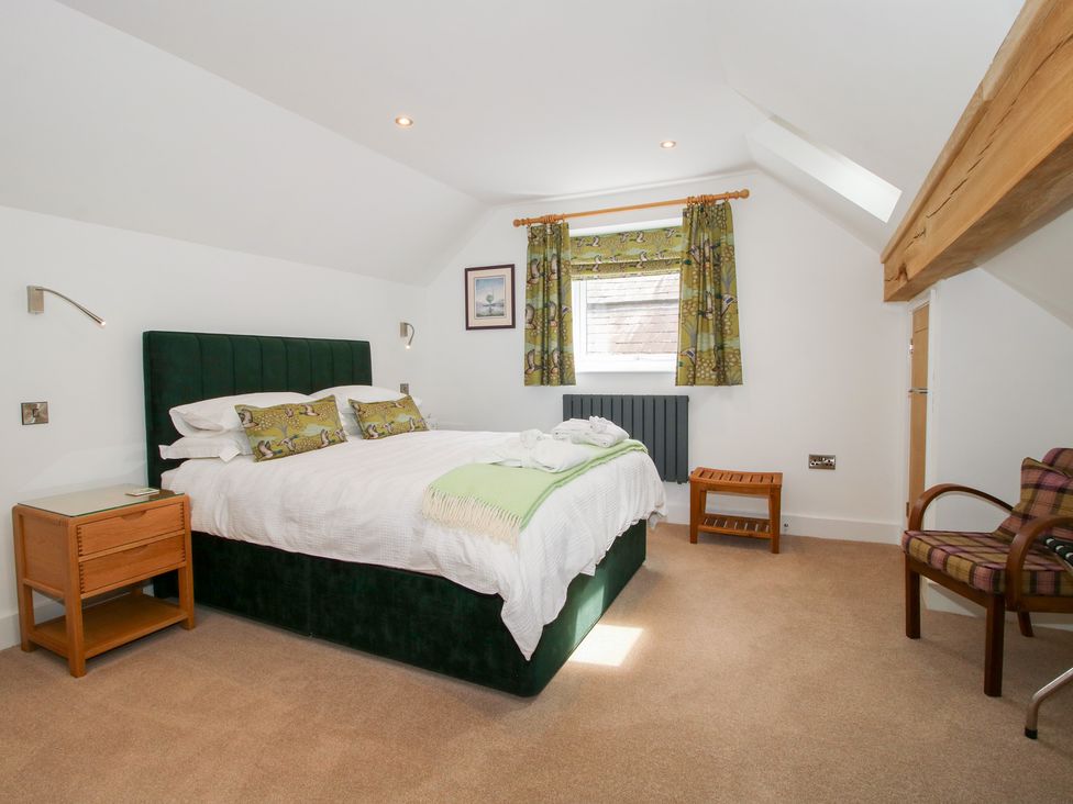 A bedroom with a bed and nightstand at Sylva Cottage in Burlton near Cockshutt