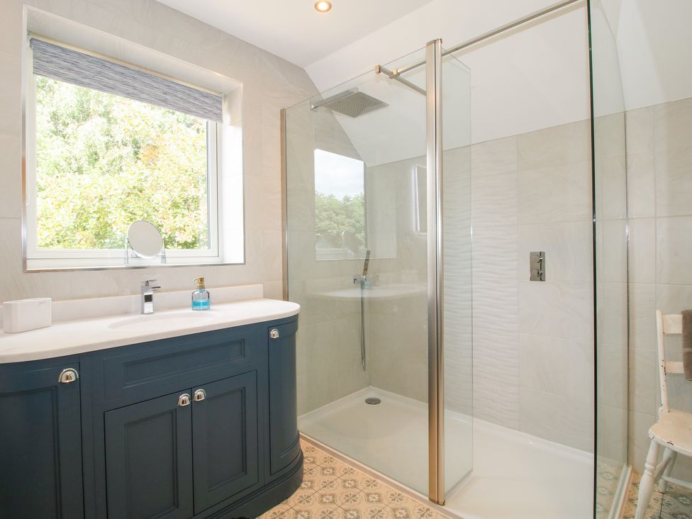 A bathroom with a shower and vanity unit at Sylva Cottage Burlton near Cockshutt