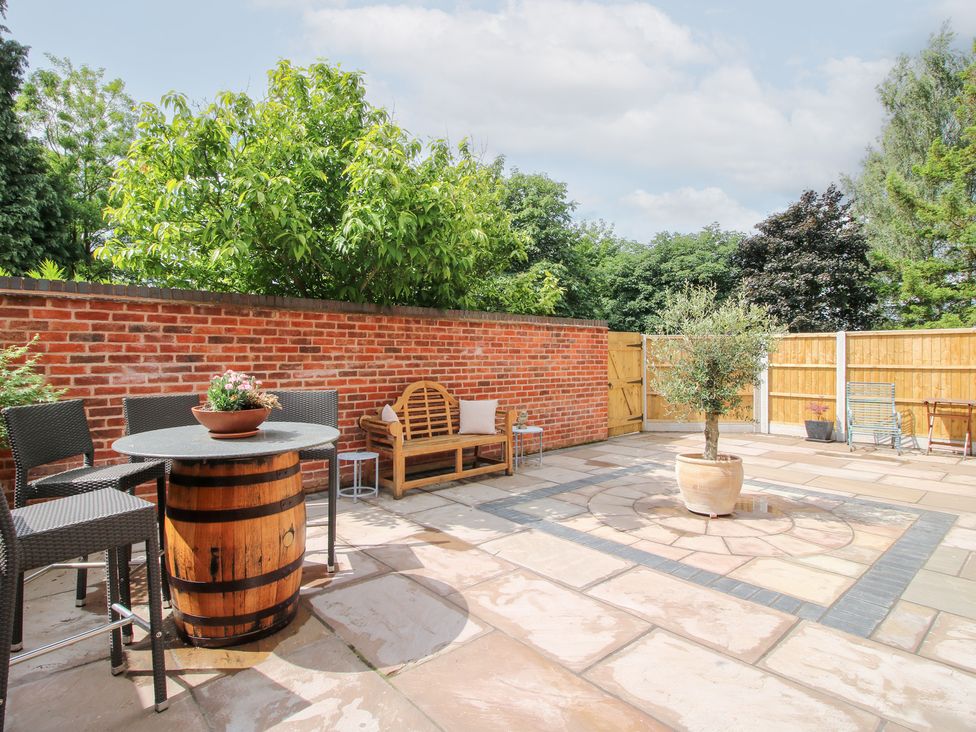 A garden with seating and a table at Sylva Cottage in Burlton near Cockshutt