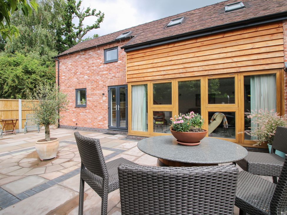 Outdoor area with seating and plants at Sylva Cottage in Burlton near Cockshutt