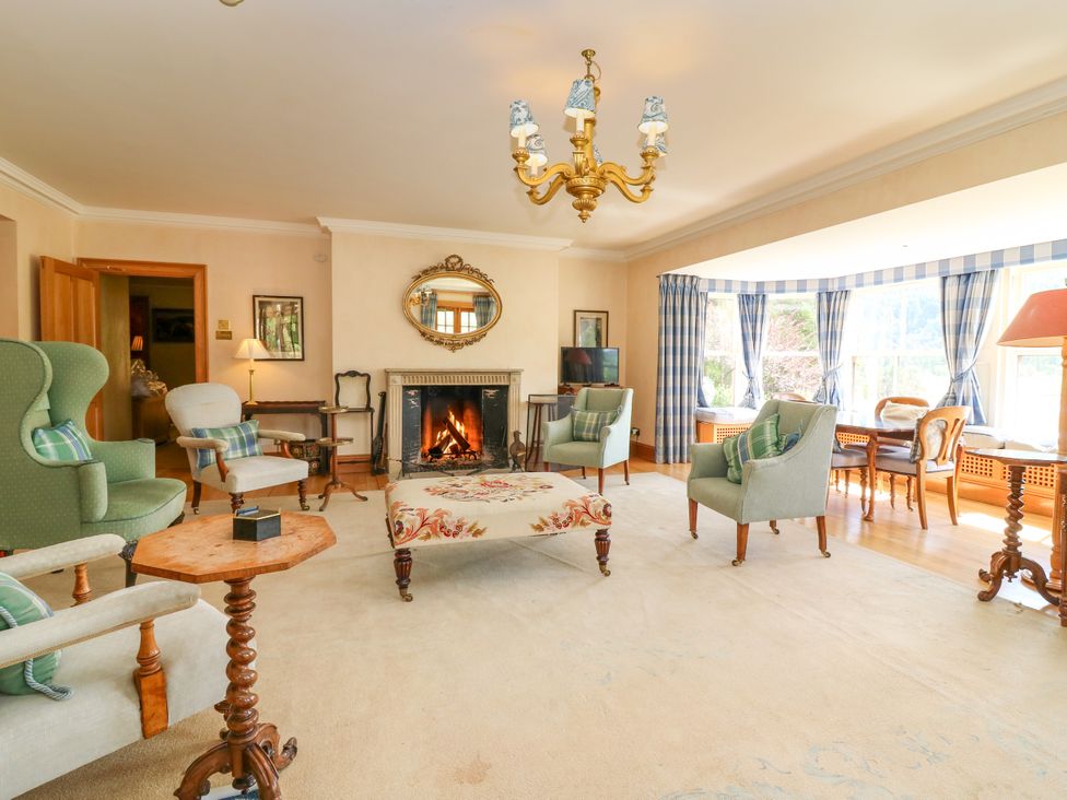 A living room with a fireplace and seating at Claybockie near Braemar