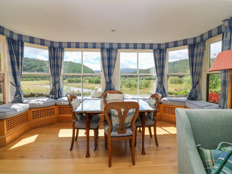 A dining room with a table and chairs at Claybockie near Braemar