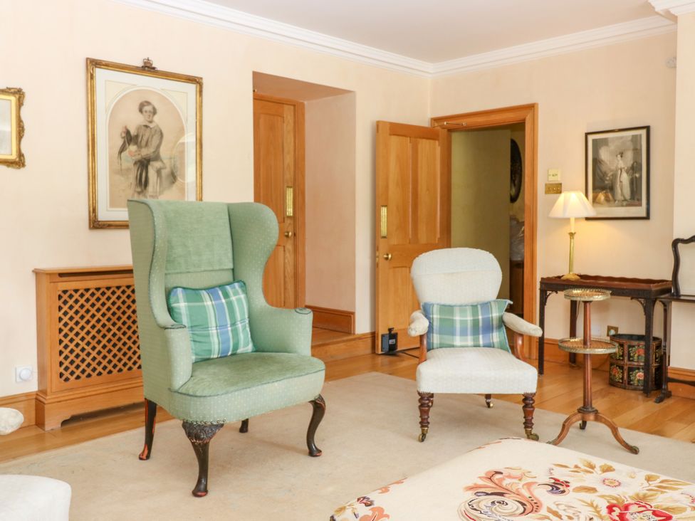 A living room with two armchairs and a side table at Claybockie near Braemar