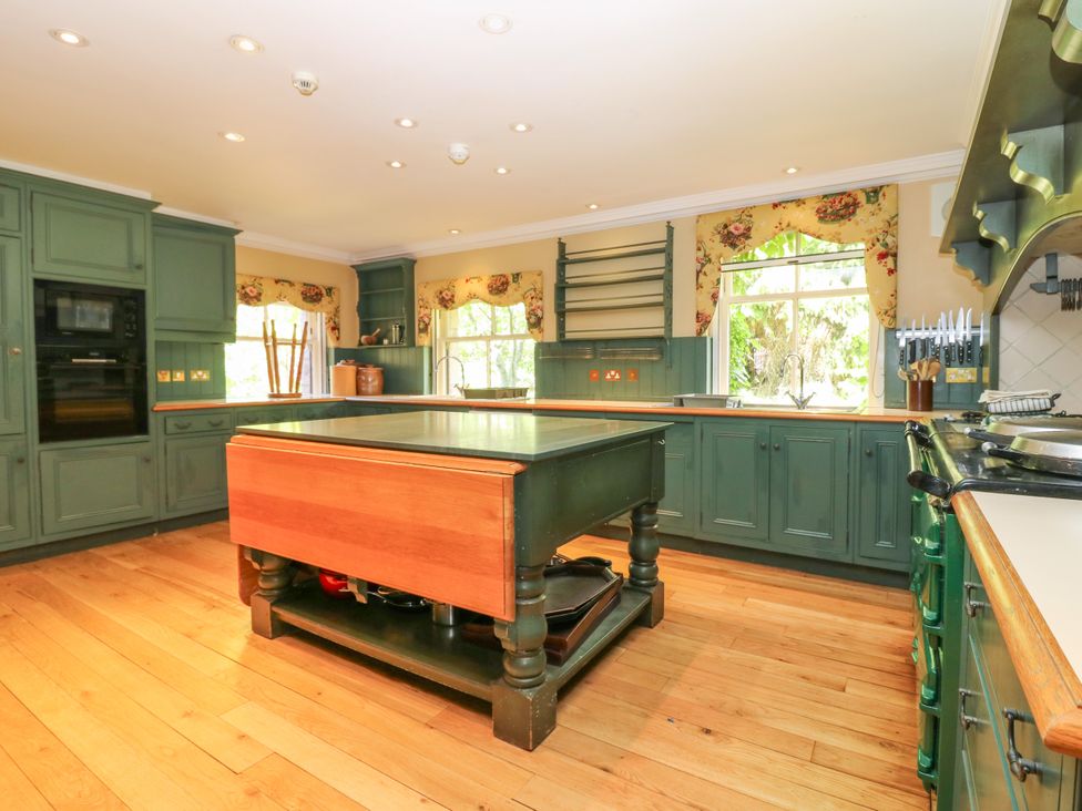 A kitchen with cabinets and island at Claybockie near Braemar