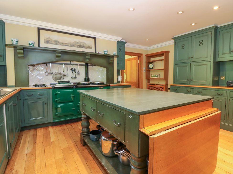 A kitchen with an island and cooking utensils at Claybockie near Braemar