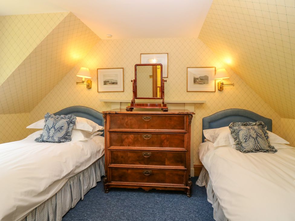 A bedroom with two beds and a chest of drawers at Claybockie near Mar Lodge near Braemar