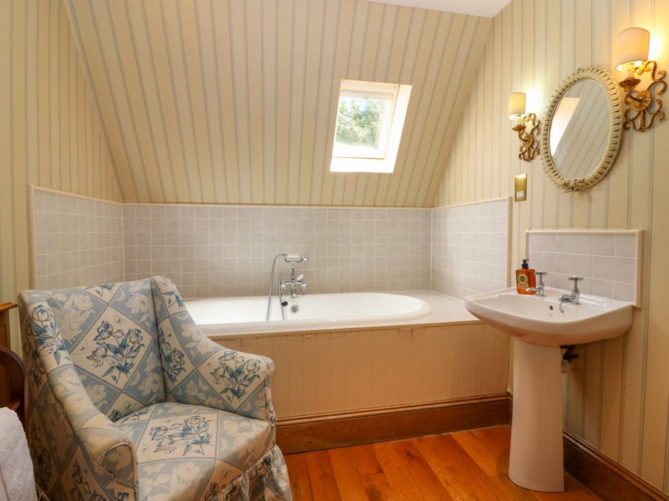 A bathroom with a bath tub and a sink at Claybockie near Mar Lodge Braemar