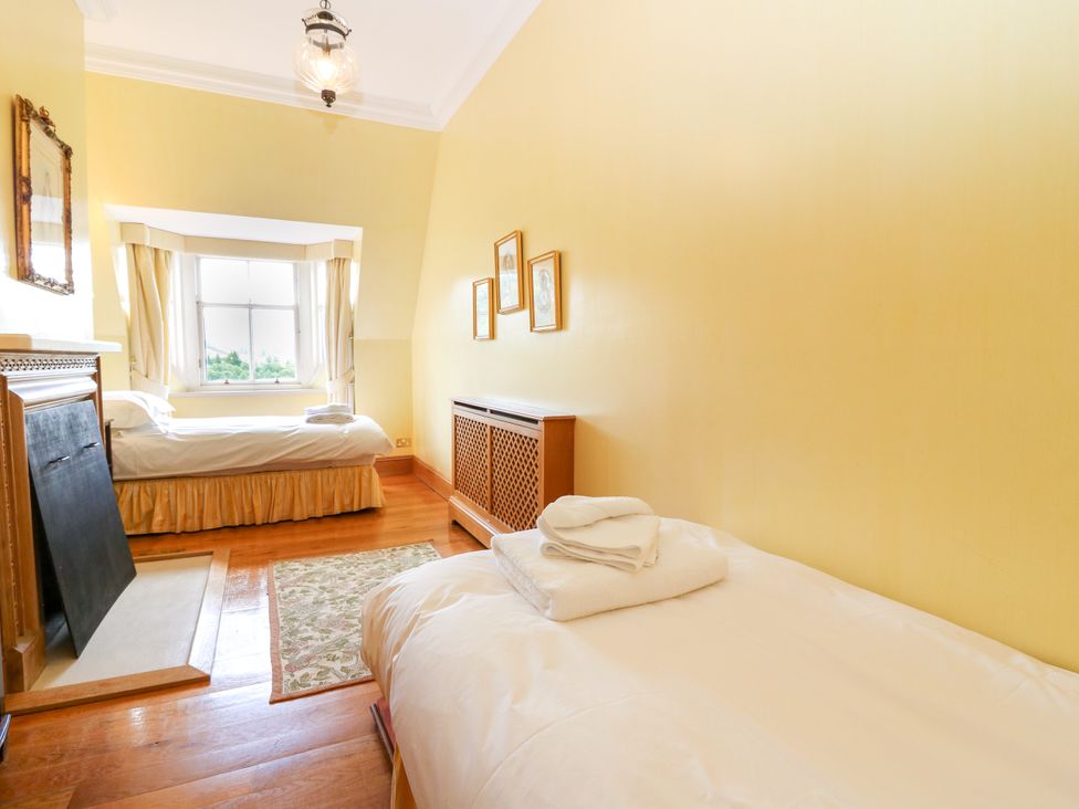 A bedroom with two beds and a window at Claybockie Mar Lodge near Braemar