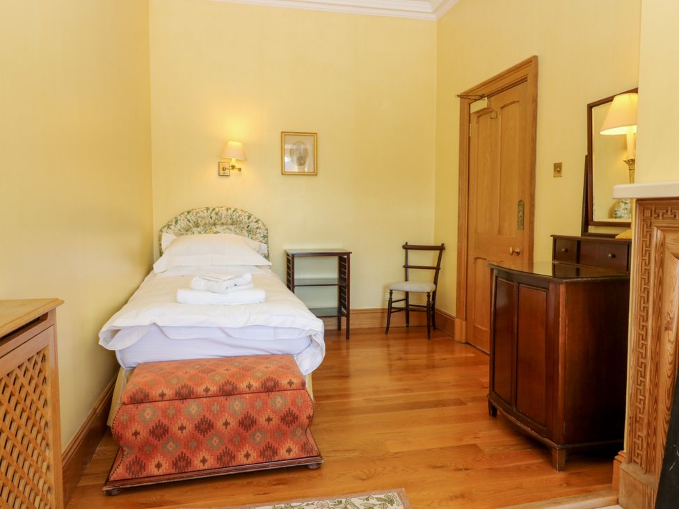 A bedroom with a single bed and furniture at Claybockie near Mar Lodge near Braemar