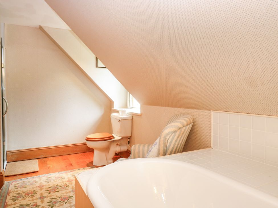 A bathroom with a bathtub and toilet at Claybockie Mar Lodge near Braemar