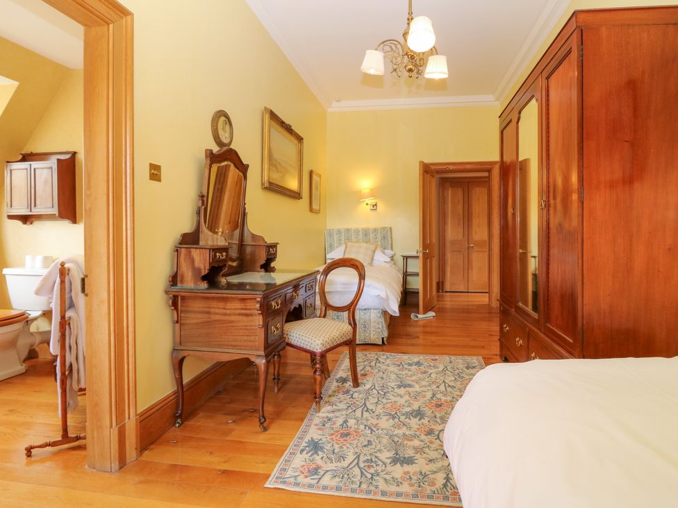 A bedroom with a chair and desk at Claybockie near Braemar