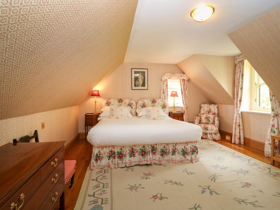 A bedroom with a double bed and furniture at Claybockie, Mar Lodge near Braemar