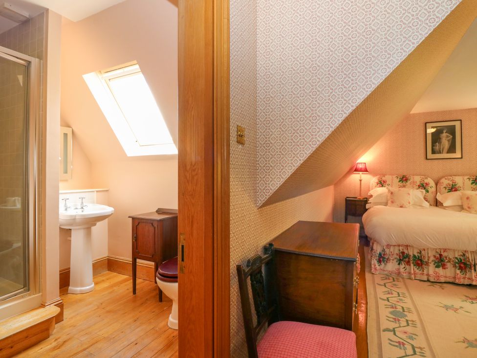 A bedroom with a bed and a connected bathroom at Claybockie near Braemar