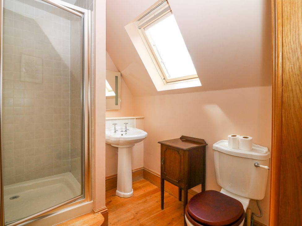A bathroom with a shower, sink, and toilet at Claybockie near Braemar
