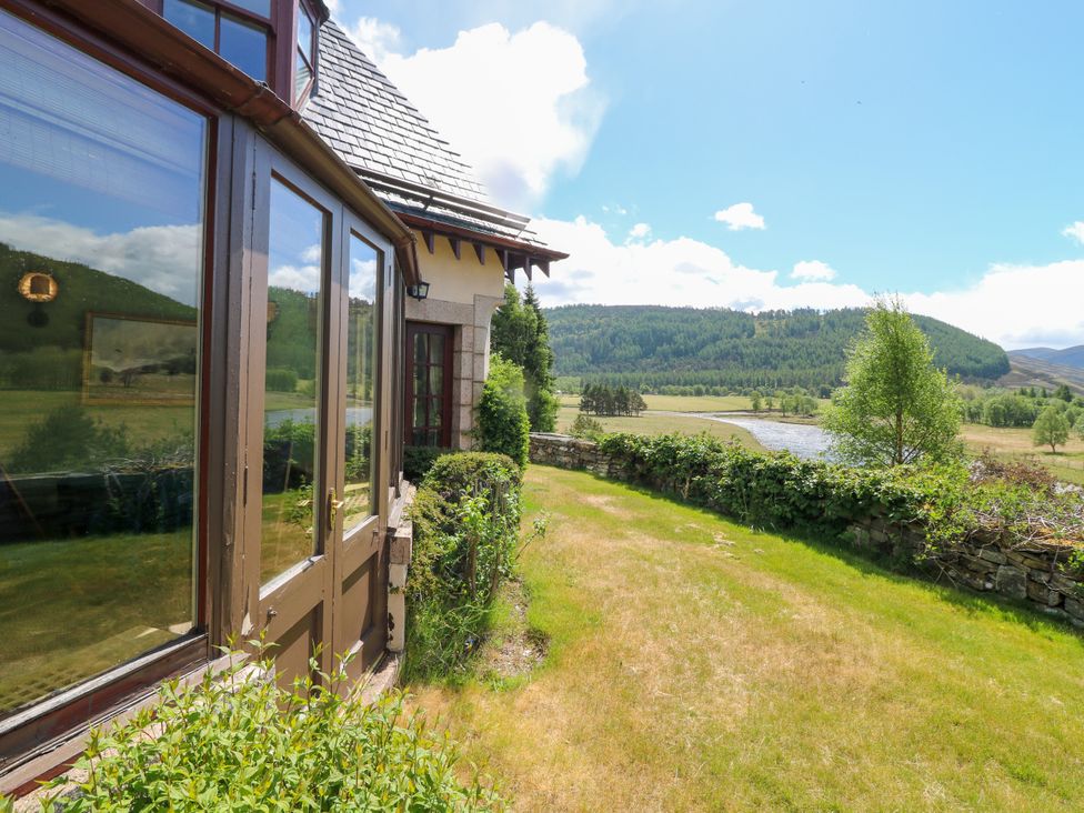 An outdoor area with a view of hills and a river at Claybockie, Mar Lodge near Braemar