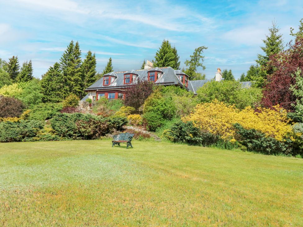 A garden with a house and bench at Claybockie near Braemar