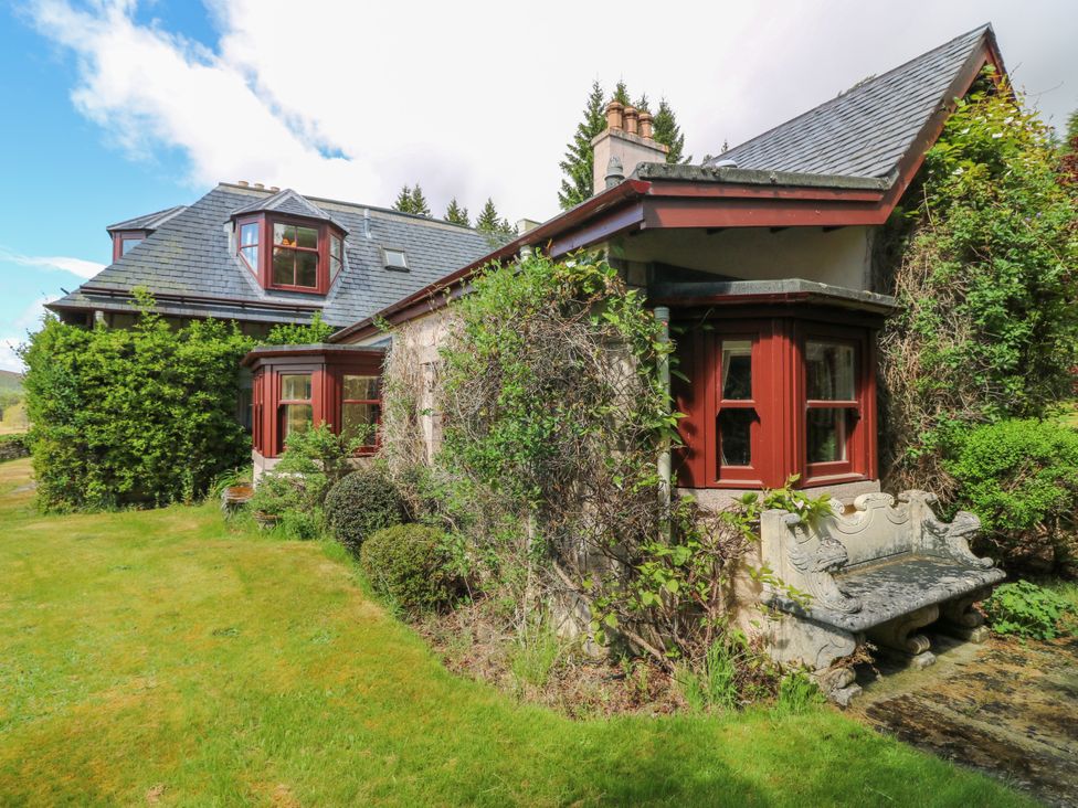A house exterior with garden bench at Claybockie near Mar Lodge