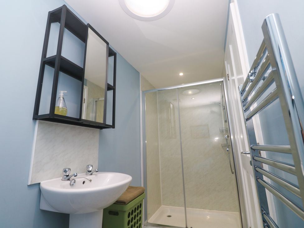 A bathroom featuring a sink, shower, and mirror at The Stable in Rosudgeon