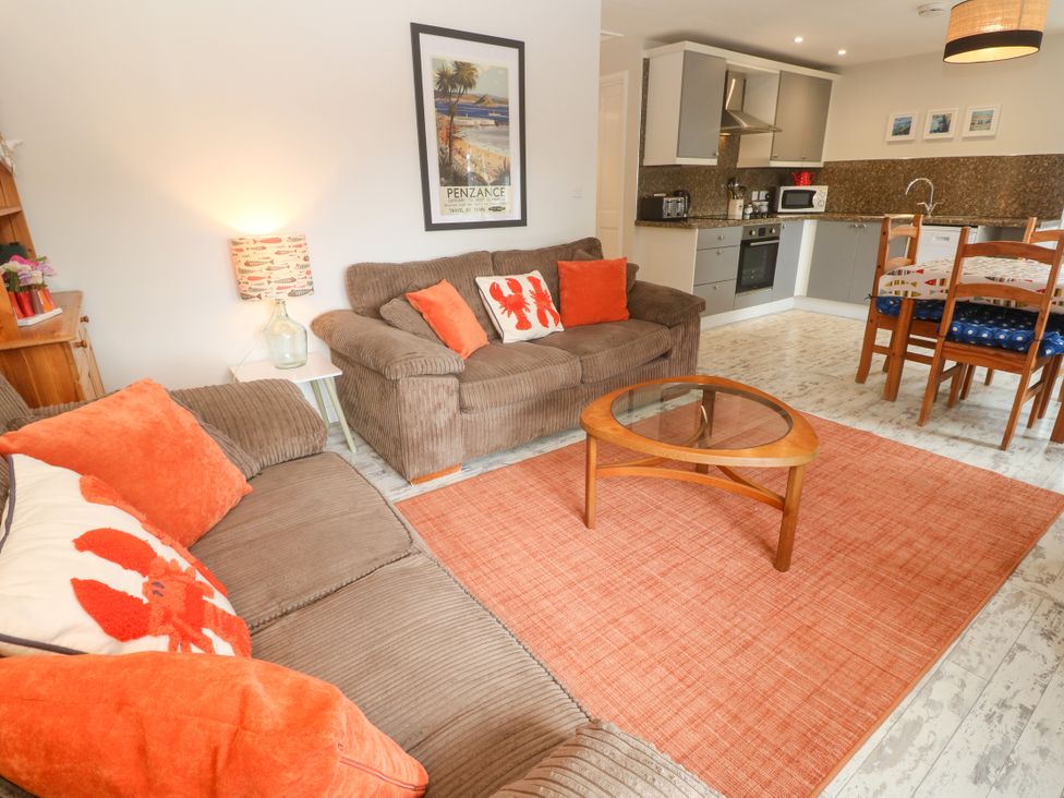 A living room with a sofa and coffee table at Sea View Loft in Rosudgeon