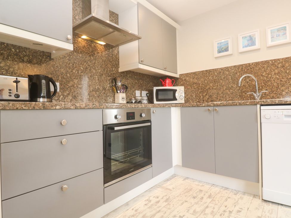 A kitchen with appliances including an oven and microwave at Sea View Loft in Rosudgeon