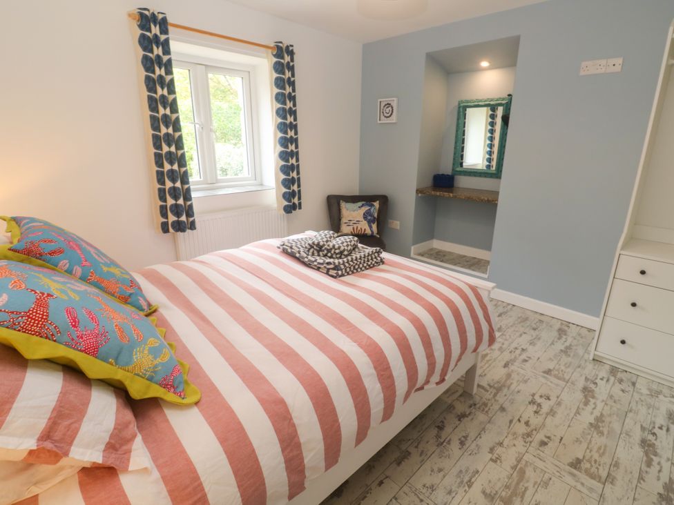 A bedroom with a bed and window at Sea View Loft in Rosudgeon