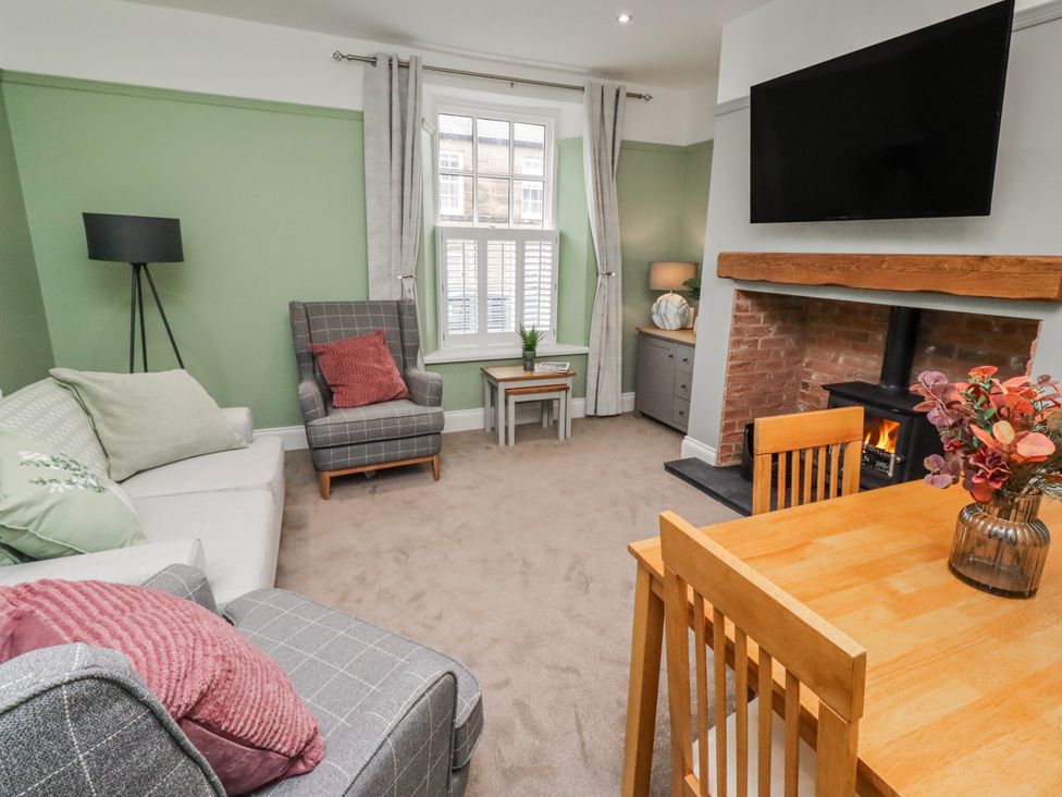 A living room with a sofa and dining table at 3 Lisburn Street Alnwick