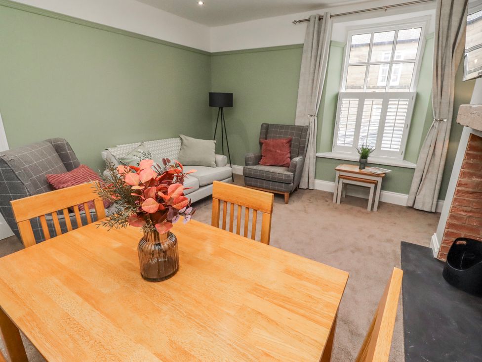 A living room with a table and chairs at 3 Lisburn Street Alnwick