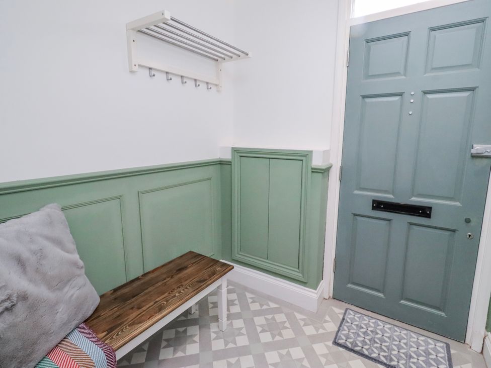 A hallway with a coat rack and bench at 3 Lisburn Street Alnwick