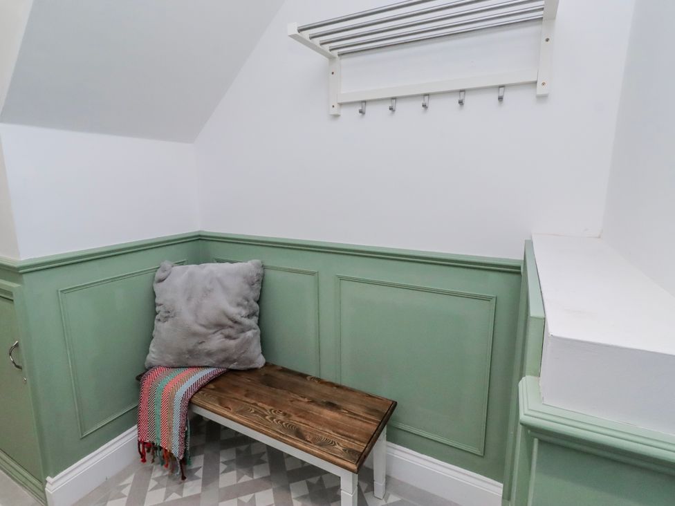 A hallway with a bench and hooks at 3 Lisburn Street Alnwick