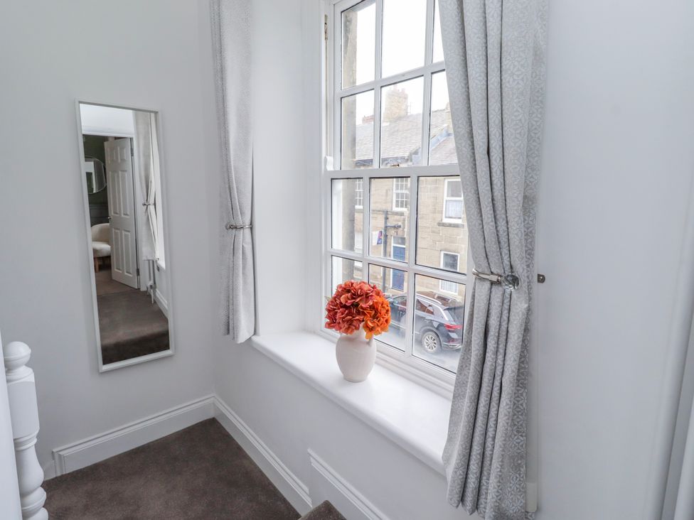 A landing with a window and a flower vase at 3 Lisburn Street Alnwick
