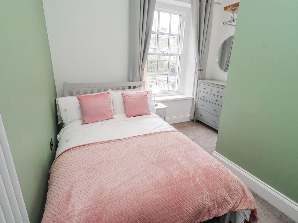 A bedroom with a bed and a dressing table at 3 Lisburn Street Alnwick
