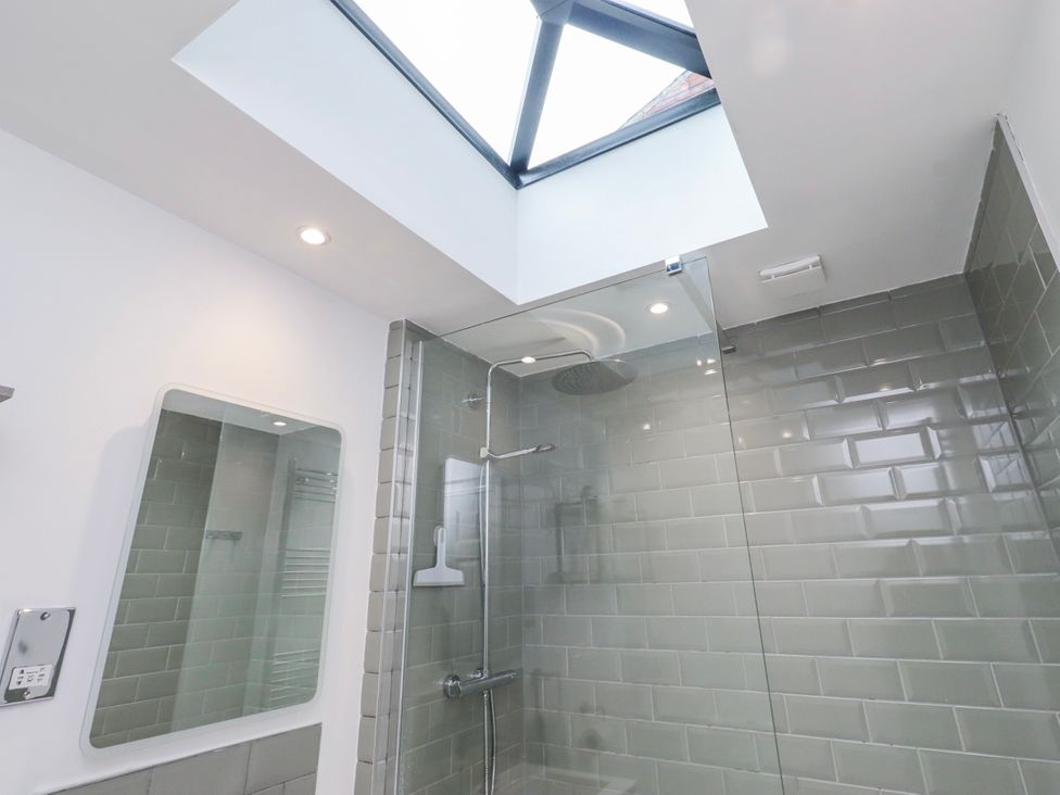 A bathroom with a shower enclosure and skylight at 3 Lisburn Street Alnwick