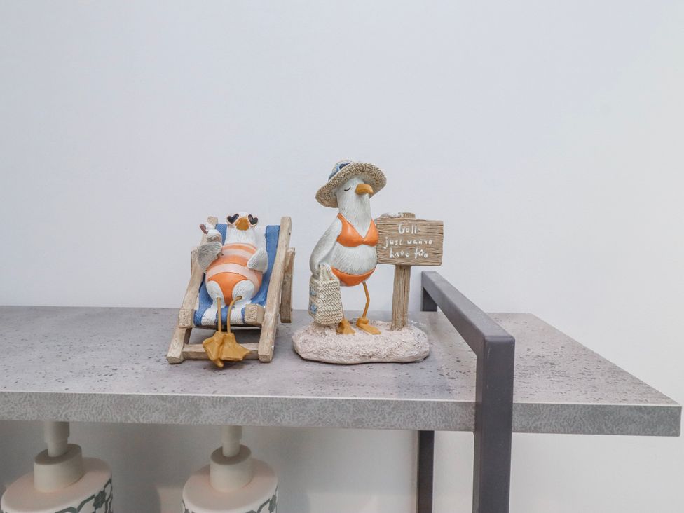 Figurines of birds and a beach chair on a table at 3 Lisburn Street Alnwick