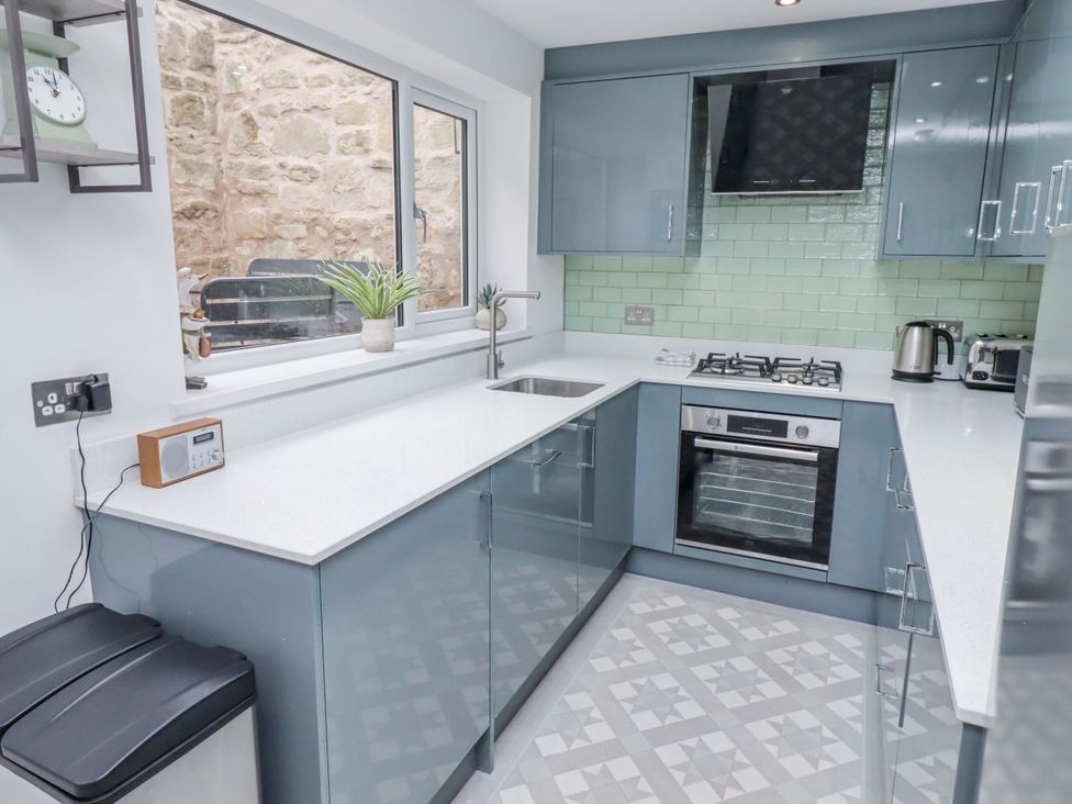 A kitchen with modern appliances and a sink at Middle Cottage in Alnwick