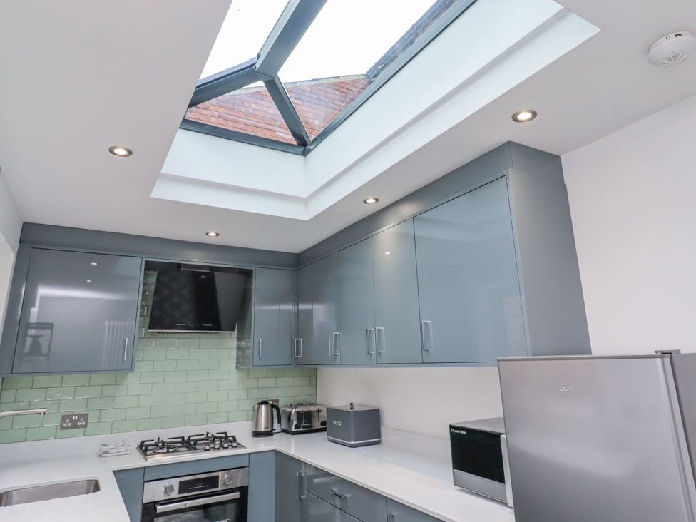 A kitchen with cabinets and appliances at Middle Cottage in Alnwick